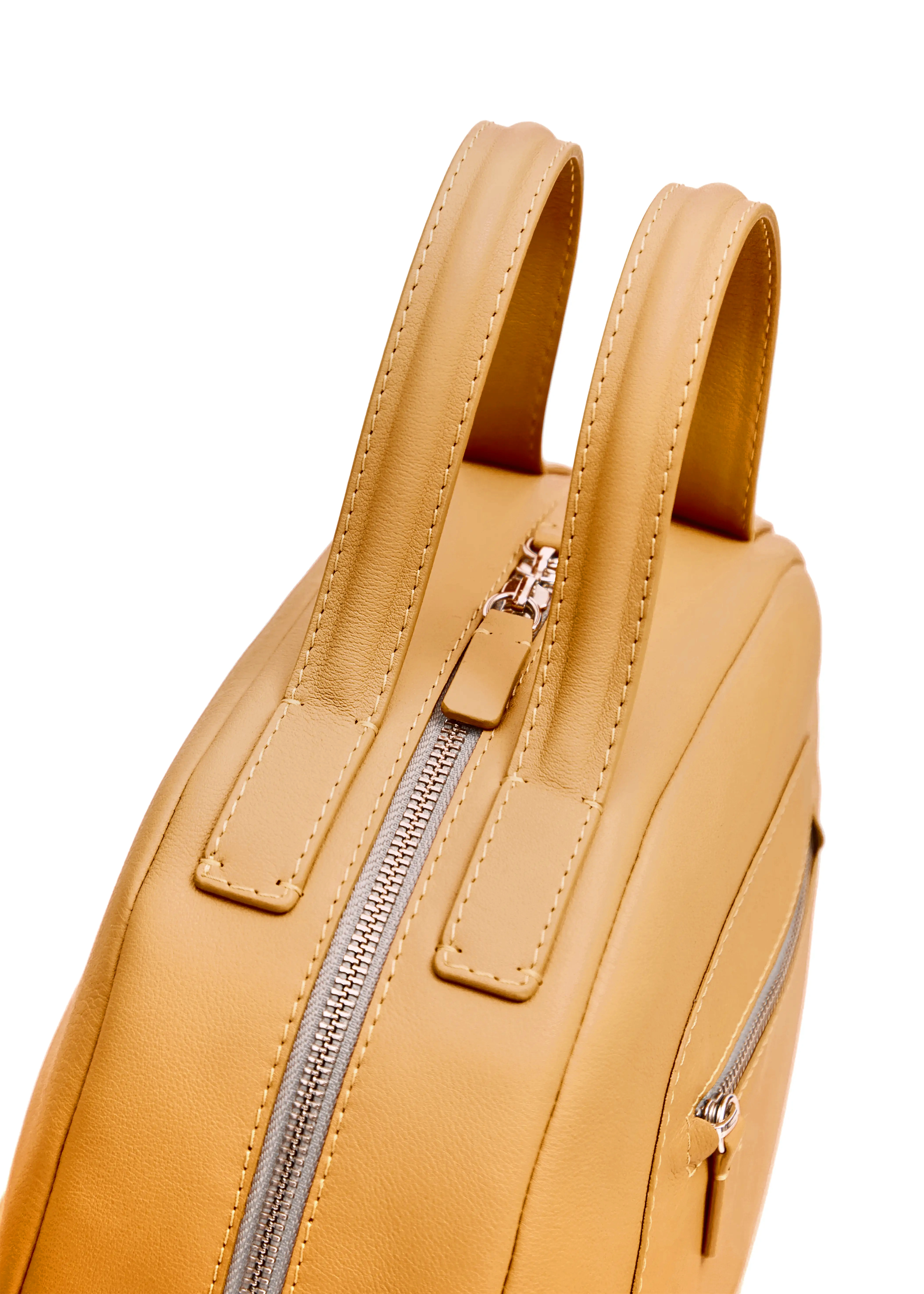 Top view of the Philini Domi Yellow Dome Handbag in premium nappa leather, featuring silver rivets, zipper, and short leather handles. Minimalist leather bag for elegant everyday use.