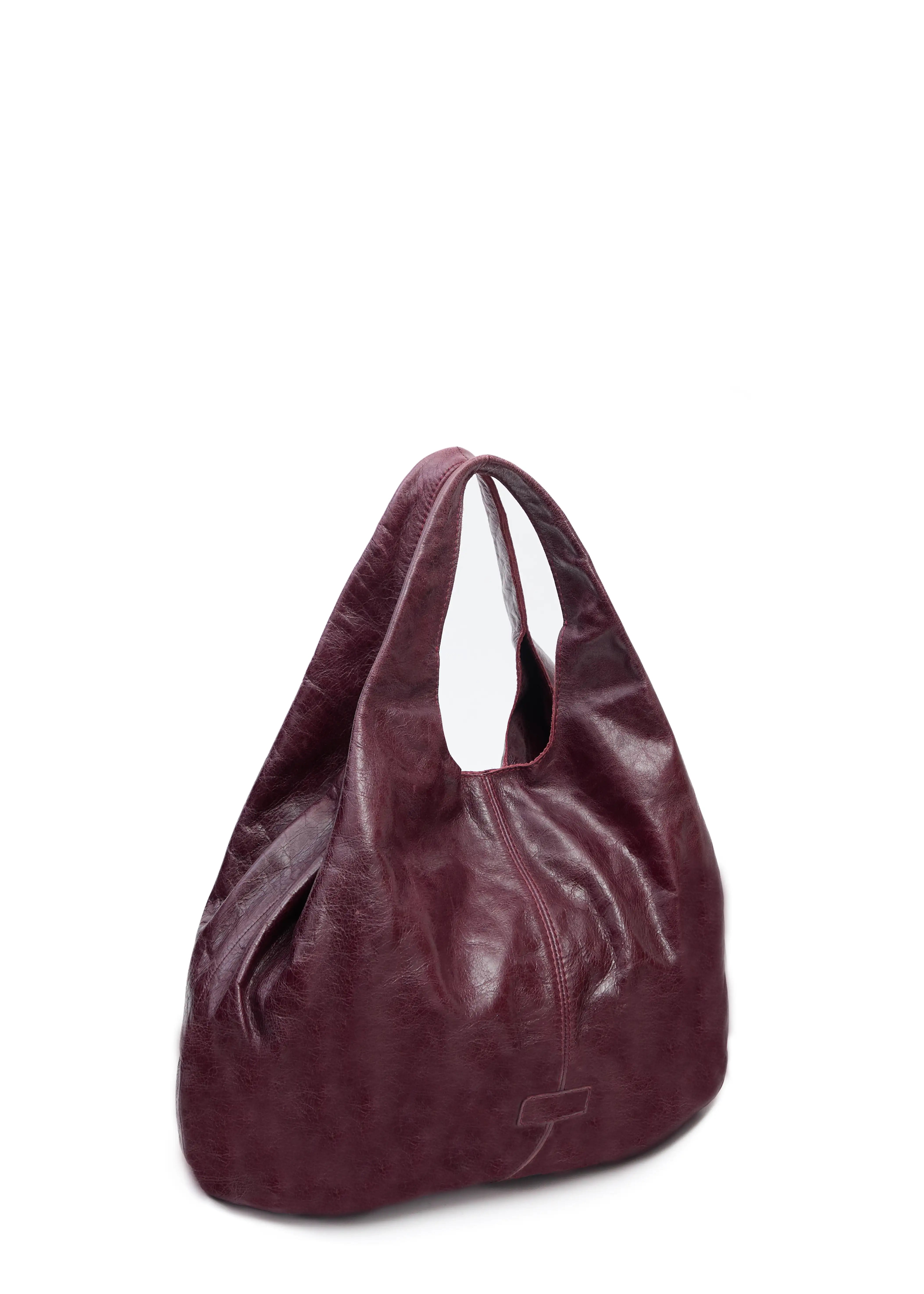 Side view of the Philini Melanie Hobo Bag in burgundy calf leather, featuring two top handles and a leather patch with stamped logo. High-quality slouchy hobo bag