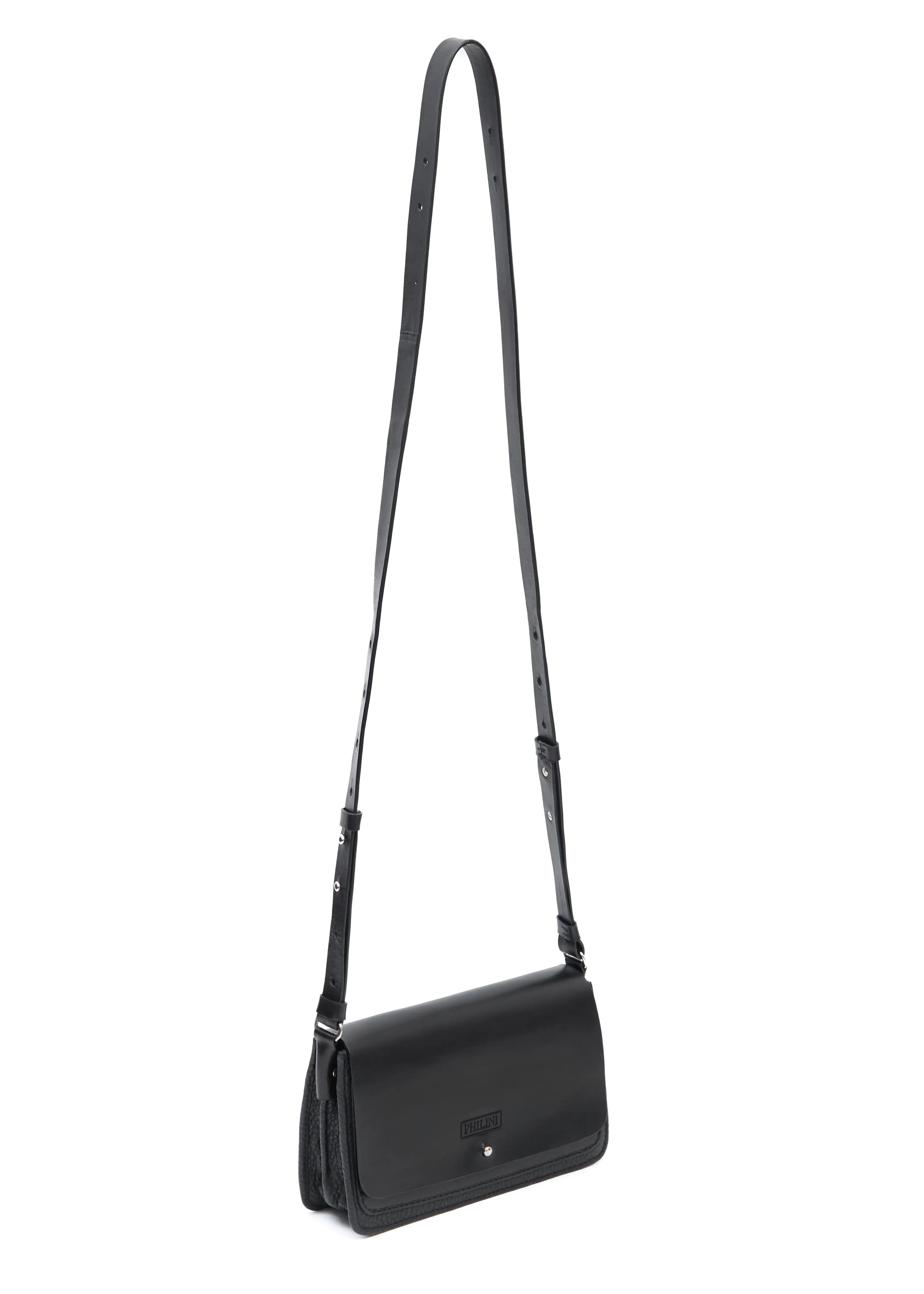 Philini Mihaela Black wallet bag featuring a full-grain leather front flap, buffalo leather accordion sides, a silver-tone cufflink closure and an adjustable leather strap with silver-tone accents. 