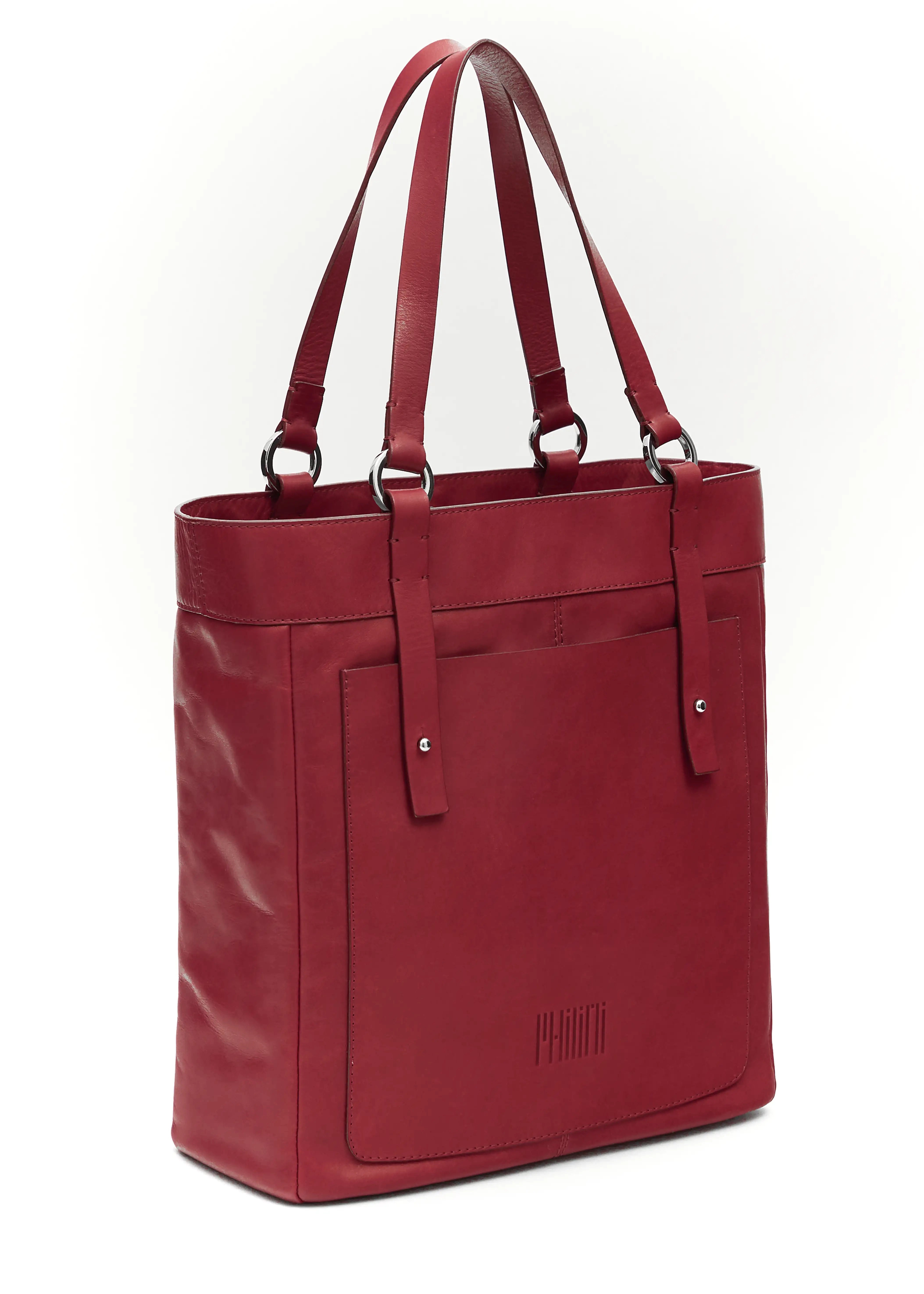 Side view of the Philini Elena Red Tote Bag in red aniline leather, featuring a leather exterior pocket and silver hoop accents on the handles. This sustainable tote combines modern elegance with practical design