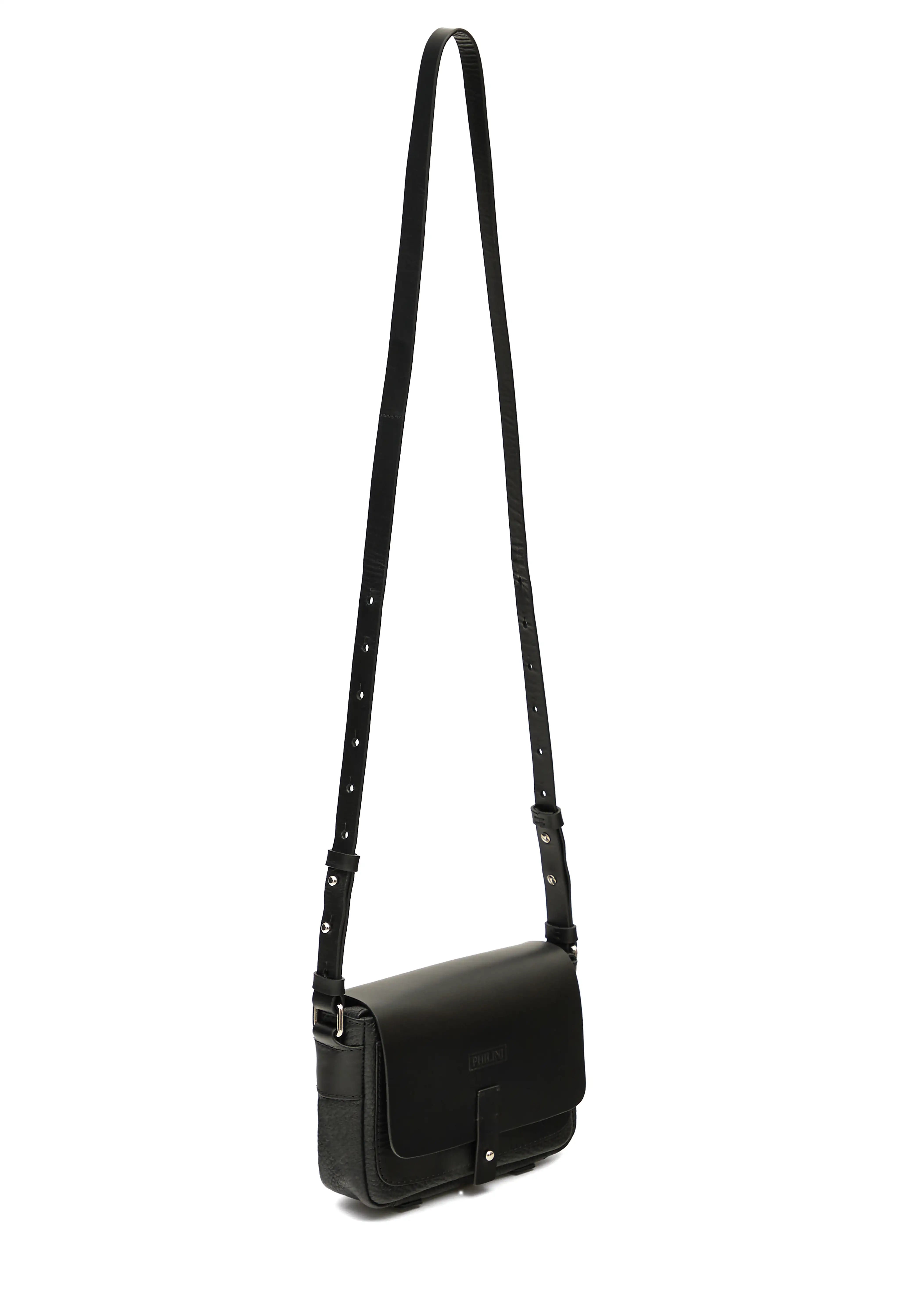 Side view of the Philini Whitney Black Leather Bag, a handcrafted designer bag with a rectangular shape, premium full-grain leather front flap, silver push-button closure, and an adjustable strap with silver accents. Designed in Germany from sustainable materials.