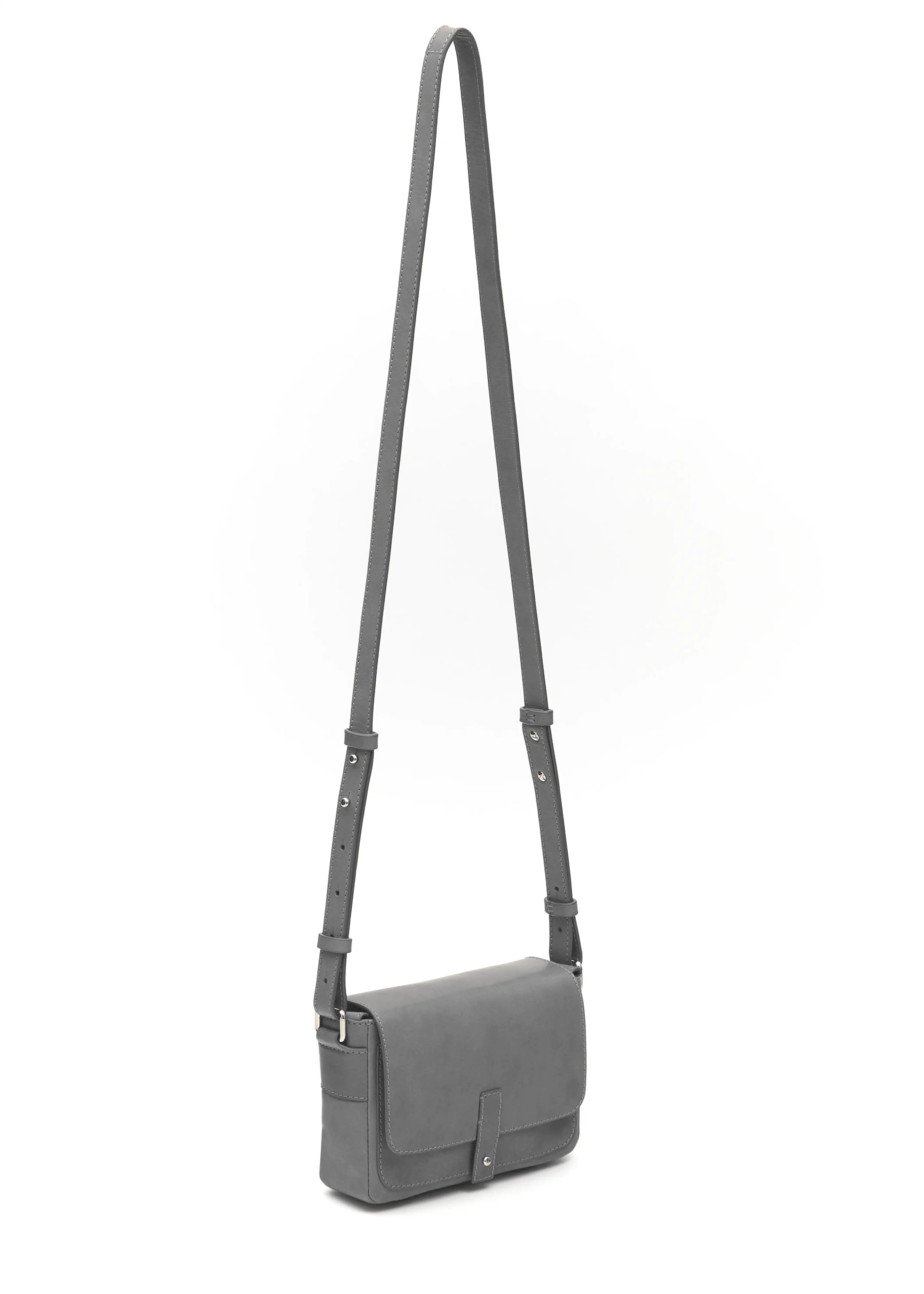Side view of the grey Philini Whitney Mini Crossbody Bag in nappa leather with a rectangular shape, silver closure, and adjustable strap. A compact handcrafted bag for daily wear and polished style